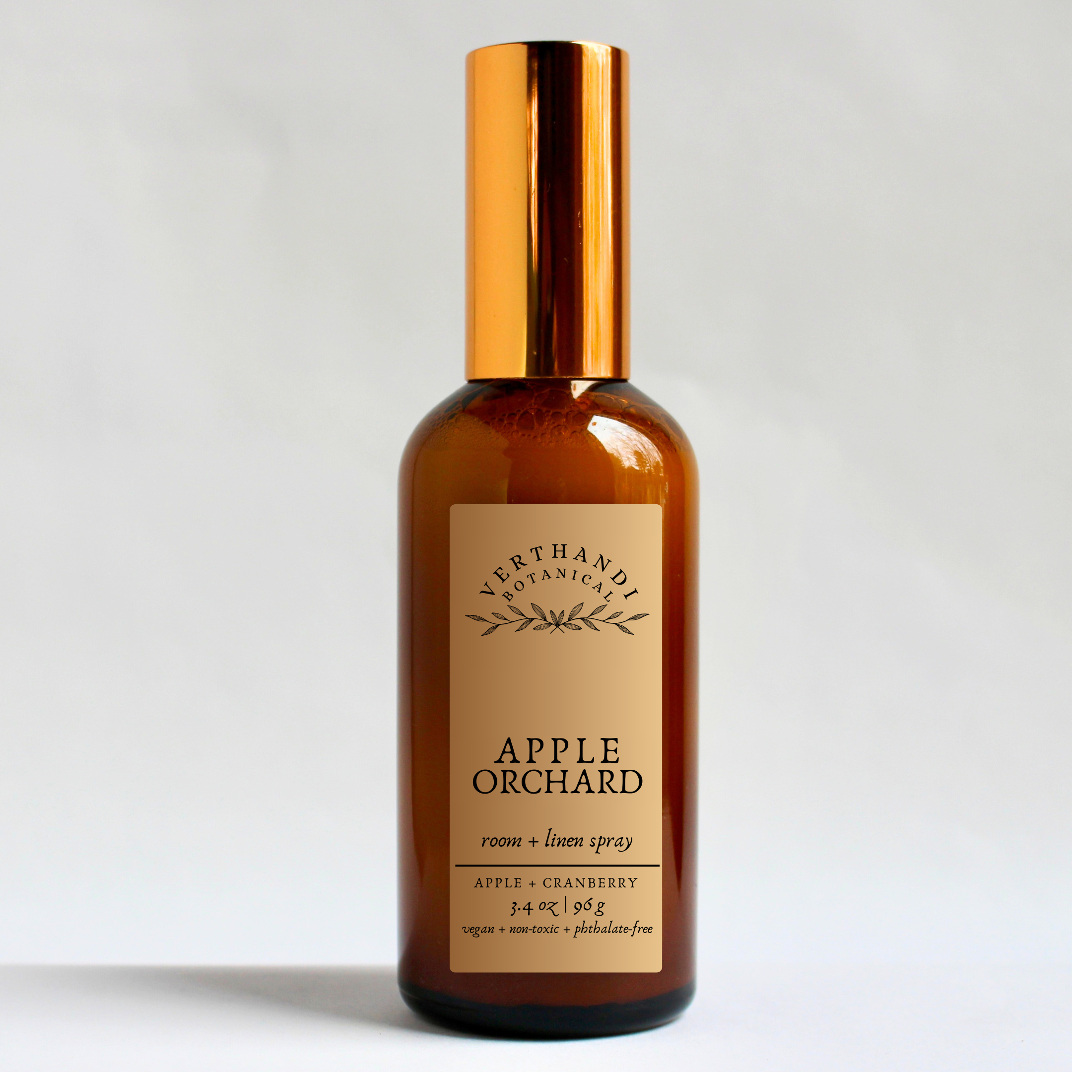 apple orchard room and linen spray in an amber glass bottle
