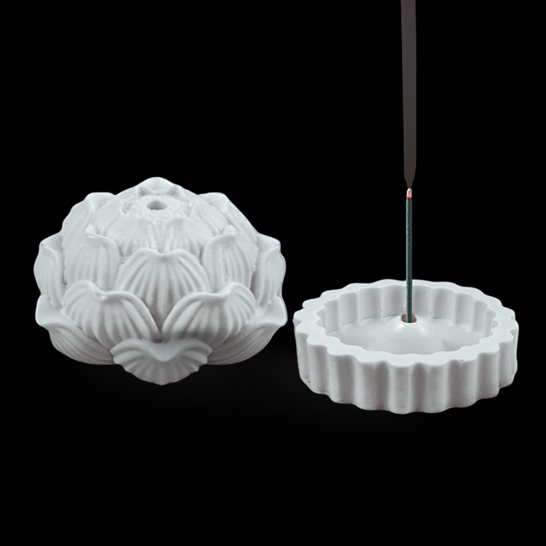 White concrete incense burner shaped like a lotus flower with an incense stick on a black background