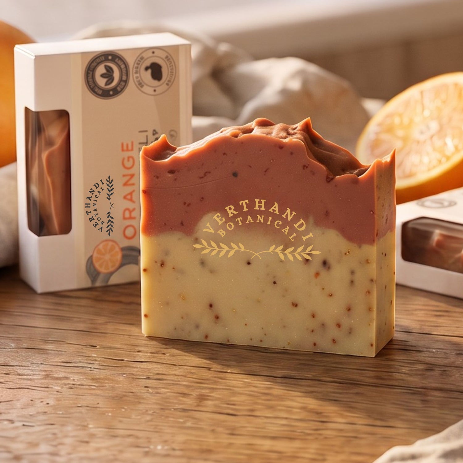 Orange Patchouli essential oil scented natural soap bar with packaging and oranges in the background. 