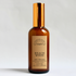 beach wood room and linen spray made from clean fragrance in an amber glass bottle