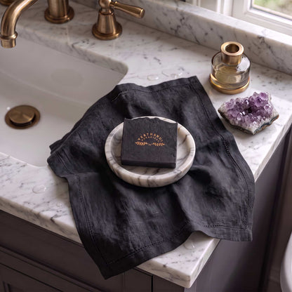 Detox Tea Tree Soap Bar by Verthandi Botanical made with charcoal and pure essential oils resting by sink.
