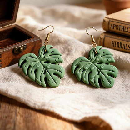 Green Monstera leaf polymer clay dangle earrings with gold-plated hooks by Verthandi Botanical